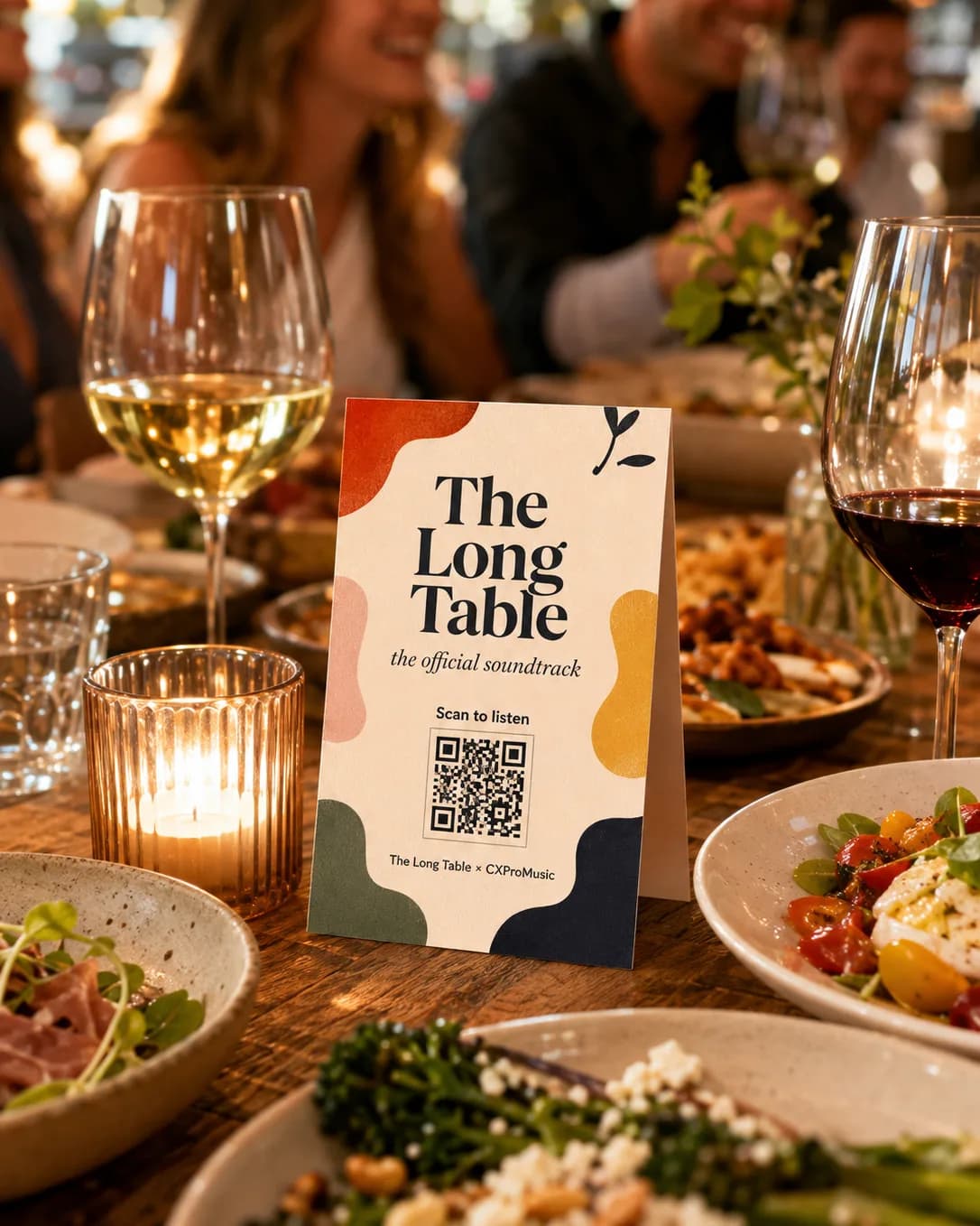 A bold table card among shared plates on a busy table.
