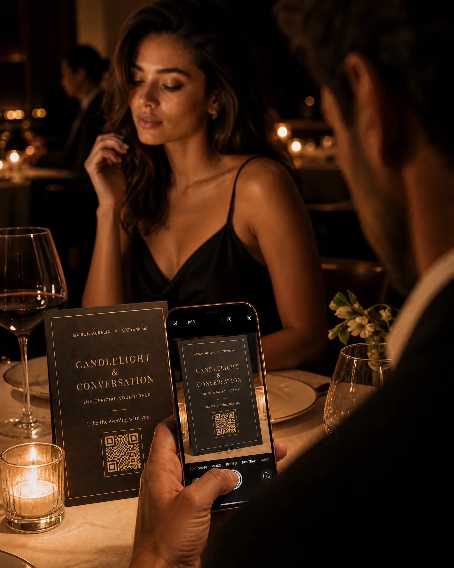 A guest raising their phone over the table card to scan it.